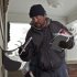 Mail carrier Zack Wyscarver delivers mail in freezing temperatures in Omaha, Neb., Monday, Dec. 5, 2011. Unprecedented cuts by the cash-strapped U.S. Postal Service will slow first-class delivery next spring and, for the first time in 40 years, eliminate the chance for stamped letters to arrive the next day. (AP Photo/Nati Harnik)
