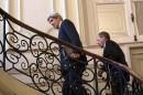 U.S. Secretary of State John Kerry, trailed by Russian Foreign Minister Sergei Lavrov, ascends the steps of the Russian Ambassador's Residence before their meeting in Paris on March 5, 2014