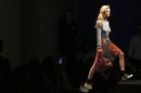 A model wears a creation for Prada men's Spring-Summer 2014 collection, part of the Milan Fashion Week, unveiled in Milan, Italy, Sunday, June 23, 2013. (AP Photo/Luca Bruno)