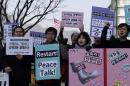 Protesters shout slogans to denounce the annual joint military exercises, dubbed Key Resolve and Foal Eagle, between South Korea and the United States, during a rally near U.S. Embassy in Seoul, South Korea, Monday, March 2, 2015. North Korea on Monday fired two short-range ballistic missiles into the sea and warned of "merciless strikes" against its enemies as allies Seoul and Washington launched annual military drills Pyongyang claims are preparation for a northward invasion. The sign read " Stop Military Drill." (AP Photo/Lee Jin-man)