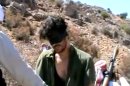 In this image taken from undated video posted to YouTube, American freelance journalist Austin Tice, who had been reporting for American news organizations in Syria until his disappearance in August 2012, prays in Arabic and English while blindfolded in the presence of gunmen. The Associated Press could not independently confirm the origin or the content of the clip, but the Tice family released a statement to several media outlets confirming it was their son in the video. Although the video footage shows a group of captors dressed and behaving like Islamic extremists, the clip lacks the customary form of jihadist videos. Previous reports have indicated that Tice is in Syrian government custody. (AP Photo)