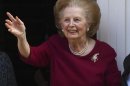 Former British Prime Minister Margaret Thatcher waves from her front doorstep as she returns home after leaving hospital in London