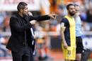 Atletico's de Madrid coach Diego Simeone from Argentina gestures to players during a Spanish La Liga soccer match against Valencia at the Mestalla stadium in Valencia, Spain, on Sunday, April 27, 2014. (AP Photo/Alberto Saiz)