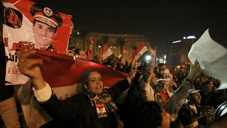 Holding national flags and portraits of military chief Gen. Abdel-Fattah el-Sissi, Egyptians celebrate the passage of a new constitution after 98.1 percent of voters supported Egypt&#39;s military-backed constitution in a two-day election, in Tahrir Square, Cairo, Egypt, Saturday, Jan. 18, 2014. In the lead up to the vote, police arrested those campaigning for a &quot;no&quot; vote on the referendum, leaving little room for arguing against the document. (AP Photo/El Shorouk Newspaper, Sabry Khaled) EGYPT OUT