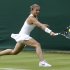 Sara Errani of Italy returns the ball to Monica Puig of Puerto Rico in their Women's first round singles match at the All England Lawn Tennis Championships in Wimbledon, London, Monday, June 24, 2013. (AP Photo/Anja Niedringhaus)