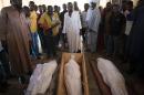 People gather around dead bodies in a mosque of the muslim district of Bangui on December 12, 2013