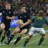 South Africa's Pat Lambie attempts to tackle New Zealand's Conrad Smith during their rugby union test match in Soweto