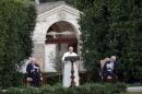 Pope Francis speaks as he is flanked by Israeli President Peres and Palestinian President Abbas in the Vatican Gardens at the Vatican