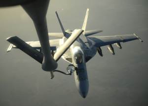 A U.S. Navy F-18E Super Hornet receives fuel from a …
