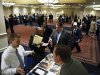 Job seekers speak with with job recruiters while they attend the Coast to Coast job fair in New York