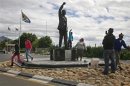 Visitors walk past a statue of Nelson Mandela outside the Victor Verster Prison near Paarl