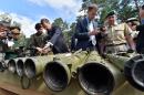 Military attaches examine a Russian weapons cache displayed in Kiev on August 29, 2014