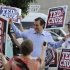 Former Texas Solicitor General Ted Cruz, center, greets supporters at a voting precinct Tuesday, July 31, 2012, in Houston. Cruz faces Lt. Gov. David Dewhurst in the Republican primary runoff election for the Republican nomination for the U.S. Senate. (AP Photo/Pat Sullivan)