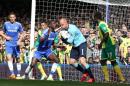 Chelsea's Demba Ba, center left, reacts as Norwich City's goalkeeper John Ruddy collects the ball after a header from Chelsea's John Terry during their English Premier League soccer match at Stamford Bridge stadium in London Sunday May 4, 2014. (AP Photo/Alastair Grant)