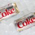 This Monday, Oct. 15, 2012 photo shows two cans of Caffeine Free Diet Coke on ice in Surfside, Fla. Coca-Cola is expected to report earnings, Tuesday, Feb. 12, 2013. (AP Photo/Wilfredo Lee)