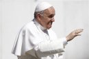 Pope Francis waves as he leads the weekly audience in Saint Peter's Square at the Vatican