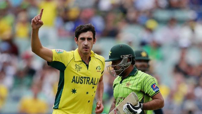Australia's Mitchell Starc, left, celebrates after taking the wicket of Pakistan's Sarfaraz Ahmed, right, during their Cricket World Cup quarterfinal match in Adelaide, Australia, Friday, March 20, 2015.(AP Photo/Rob Griffith)