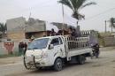 A van carries the coffin of person killed fighting with Iraqi forces in the Anbar provincial capital of Ramadi, west of Baghdad, on December 31, 2013