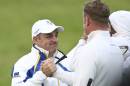 Europe team captain Paul McGinley congratulates Jamie Donaldson, right, on the 17th green after winning the foursomes match on the second day of the Ryder Cup golf tournament, at Gleneagles, Scotland, Saturday, Sept. 27, 2014. (AP Photo/Peter Morrison)