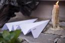 Paper planes and a candle are placed in front of the Dutch embassy in Moscow on July 17, 2015 in memory of the people who died in the crash of Malaysian Airlines flight MH17