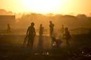 AP10ThingsToSee - Afghan refugee children play in a field as the sun sets on the outskirts of Islamabad, Pakistan, Monday, Nov. 25, 2013. (AP Photo/Muhammed Muheisen, File)