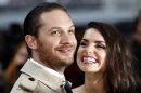 British actor Tom Hardy and his girlfriend Charlotte Riley pose for photographers as they arrive at the European Premiere of "The Dark Knight Rises" in Leicester Square