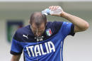 Italy defender Giorgio Chiellini drops water as he refreshes during a training session of Italy in Mangaratiba, Brazil, Saturday, June 7, 2014. Italy play in group D of the 2014 soccer World Cup. (AP Photo/Antonio Calanni)