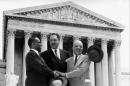 FILE - This May 17, 1954 file photo shows, from left, George E.C. Hayes, Thurgood Marshall, and James M. Nabrit joining hands as they pose outside the Supreme Court in Washington. The three lawyers led the fight for abolition of segregation in public schools before the Supreme Court, which ruled today that segregation is unconstitutional. On May 17, 1954, a hushed crowd of spectators packed the Supreme Court, awaiting word on Brown v. Board of Education, a combination of five lawsuits brought by the NAACP's legal arm to challenge racial segregation in public schools. The high court decided unanimously that "separate but equal" education denied black children their constitutional right to equal protection under the law, effectively removing a cornerstone that propped up Jim Crow, or state-sanctioned segregation of the races. (AP Photo, File)