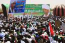 Supporters of Sudan's President Omar al-Bashir (portraits) gather for a rally before the upcoming presidential elections in El-Fasher, in North Darfur, on April 8, 2015