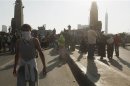 Opponents of deposed President Mursi, stand among police officers after report of possible pro-Mursi rally, near Tahrir square, in Cairo
