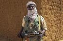 A fighter with the Tuareg separatist group MNLA stands guard outside the local regional assembly in Kidal