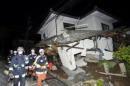 Firefighters check collapsed house after an earthquake in Mashiki town, Kumamoto prefecture, southern Japan