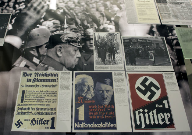 A poster, front center, showing Adolf Hitler, right, and Reich Chancellor Paul von Hindenburg, left, is pictured at the 'Berlin 1933 - the way to despotism' exhibition at the Topography of Terror museum in Berlin, Germany, Wednesday, Jan. 30, 2013. The Topography of Terror museum is located at the area where the headquarters of the Gestapo and SS were destroyed by allied bombing. (AP Photo/Michael Sohn)