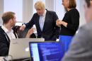 London Mayor Boris Johnson, center, speaks with Will Drevo, CEO of pharmaceutical analytics company Datasight, left, and Professor Fiona Murray, right, at the Innovation Initiative Center at the Massachusetts Institute of Technology, Monday, Feb. 9, 2015, in Cambridge, Mass. Johnson is on a six-day trade mission to the U.S., including stops in New York and Washington. (AP Photo/Josh Reynolds)
