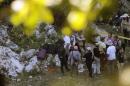Forensic personnel arrive at the scene where a new mass grave has been discovered in a trash dump on the outskirts of Cocula, Guerrero state, Mexico on October 27, 2014