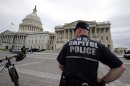 A law enforcement officer stands post at the U.S. Capitol, Monday, April 15, 2013 in Washington. Authorities say the blasts during the Boston Marathon killed two people and injured at least 73,(AP Photo/Alex Brandon)
