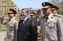 File photo of Egypt's President Mursi visiting the tomb of ex-President al-Sadat and the Tomb of the Unknown Soldier during the commemoration of Sinai Liberation Day in Cairo