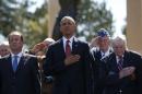 U.S. President Barack Obama and French President Francois Hollande stand with veterans in Colleville-sur-Mer
