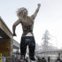 An activist of the Ukrainian feminist  group FEMEN stands on a fence during a protest at the 43rd Annual Meeting of the World Economic Forum, WEF, in Davos, Switzerland, Saturday, Jan. 26, 2013.  (AP Photo/Keystone/Jean-Christophe Bott)