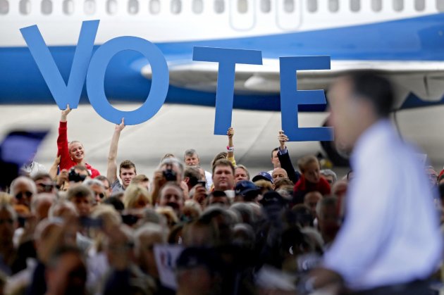 Crowd members hold up a sign reading "vote" as Republican presidential candidate, former Massachusetts Gov. Mitt Romney speaks during a campaign event at the Orlando Sanford International Airport, Monday, Nov. 5, 2012, in Sanford, Fla. (AP Photo/David Goldman)