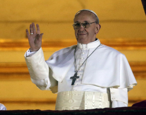 Pope Francis waves to the crowd from the central balcony of St. Peter's Basilica at the Vatican, Wednesday, March 13, 2013. Cardinal Jorge Bergoglio who chose the name of Francis is the 266th pontiff of the Roman Catholic Church. (AP Photo/Gregorio Borgia)
