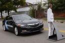 An Acura RLX sedan brakes to avoid a mannequin during Honda's Omni Directional V2X demo at the ITS World Congress in Detroit