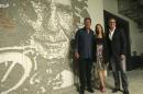In this Tuesday, Sept. 20, 2016 photo, former Miami Dolphins quarterback Dan Marino, left, Jessica Goldman Srebnick, CEO of Goldman Global Arts, center, and Tom Garfinkel, Miami Dolphins president and CEO, right, pose for a photo next to artwork by the Portuguese artist Alexandre Farto, known as Vhiles, of former Dolphins head coach Don Shula, at Hard Rock Stadium in Miami Gardens, Fla. When the Miami Dolphins play their home opener against the Cleveland Browns, it will be in a refurbished stadium that features 29,000 square feet of new, original wall art from artists from all over the world. (AP Photo/Lynne Sladky)