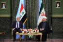 Iraqi Prime Minister Haidar al-Abadi, left, meets with Iran's President Hassan Rouhani, at Tehran's Saadabad Palace on Tuesday, Oct. 21, 2014. Rouhani said Iran will stand by its neighbor Iraq in its fight against the Sunni extremists of the Islamic State group and will continue to provide Baghdad with military advisers and weapons, according to a report by the official IRNA news agency. He also criticized the U.S. for allegedly failing to sufficiently support Iraq. (AP Photo/Ebrahim Noroozi)