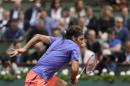Switzerland's Roger Federer rushes to the net as he plays Bosnia and Herzegovina's Damir Dzumhur during their third round match of the French Open tennis tournament at the Roland Garros stadium, Friday, May 29, 2015 in Paris. (AP Photo/Thibault Camus)