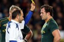 Bismarck du Plessis of South Africa (R) is yellow-carded by referee Romain Poite (L) in Auckland on September 14, 2013
