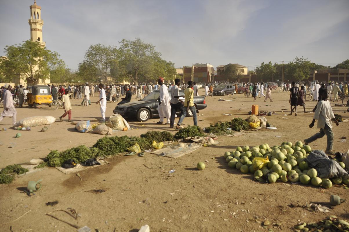People walk near the area of a bomb explosion in Kano, Nigeria, Friday Nov. 28, 2014. An explosion tore through the central mosque in Nigeria's second-largest city on Friday, and officials feared the casualty toll would be high. Capt. Ikechukwu Eze said the Friday blast occurred at the main mosque in the city of Kano. Hundreds had gathered to listen to a sermon in a region terrorized by attacks from the militant group Boko Haram. (AP Photo/Muhammed Giginyu)