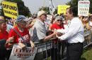 Senator Cruz greets attendees as he arrives to speak at the Tea Party Patriots 'Exempt America from Obamacare' rally on the west lawn of the U.S. Capitol in Washington