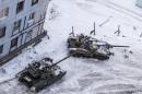 Ukrainian tanks stand in the yard of an apartment block in Avdiivka, eastern Ukraine, Wednesday, Feb. 1, 2017. Heavy fighting around government-held Avdiivka, just north of the rebel-stronghold city of Donetsk, began over the weekend and persisted into early Wednesday. The Contact Group called for the opposing sides to cease fire and urged them to pull back their heavy weapons by the end of the week. (AP Photo/Evgeniy Maloletka)