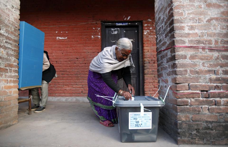 An elderly Nepalese woman casts her vote at a polling station in Bhaktapur, Nepal, Tuesday, Nov. 19, 2013. Voters casts their ballots across Nepal on Tuesday to elect a Constituent Assembly that will attempt again to write a constitution that could bring stability to the Himalayan nation. (AP Photo/Niranjan Shrestha)
